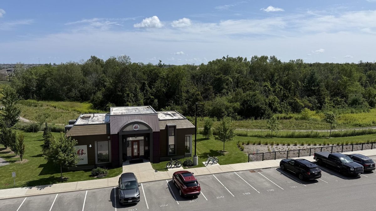 View from the balcony over the grounds and forest at 301 - 8 Culinary Lane, Barrie